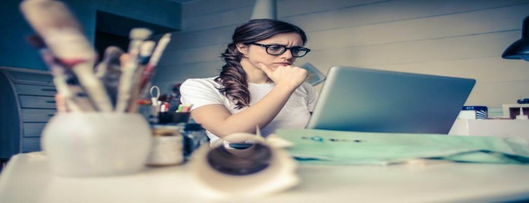 Woman looking intently at computer screen