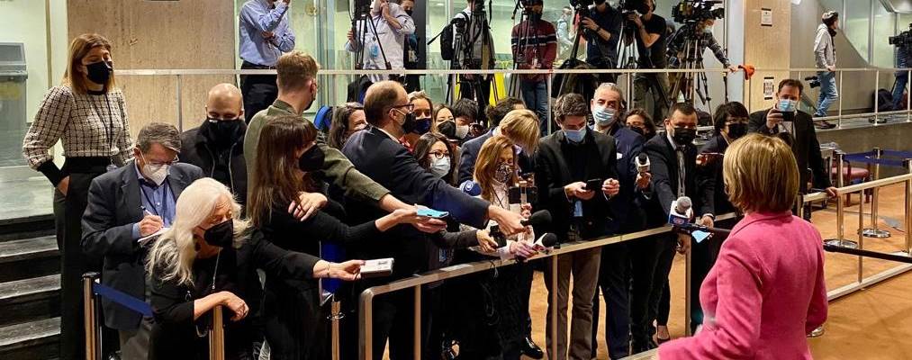 Mona Juul står sammen med et fullt pressekorps og gir intervjuer til mange journalister samtidig