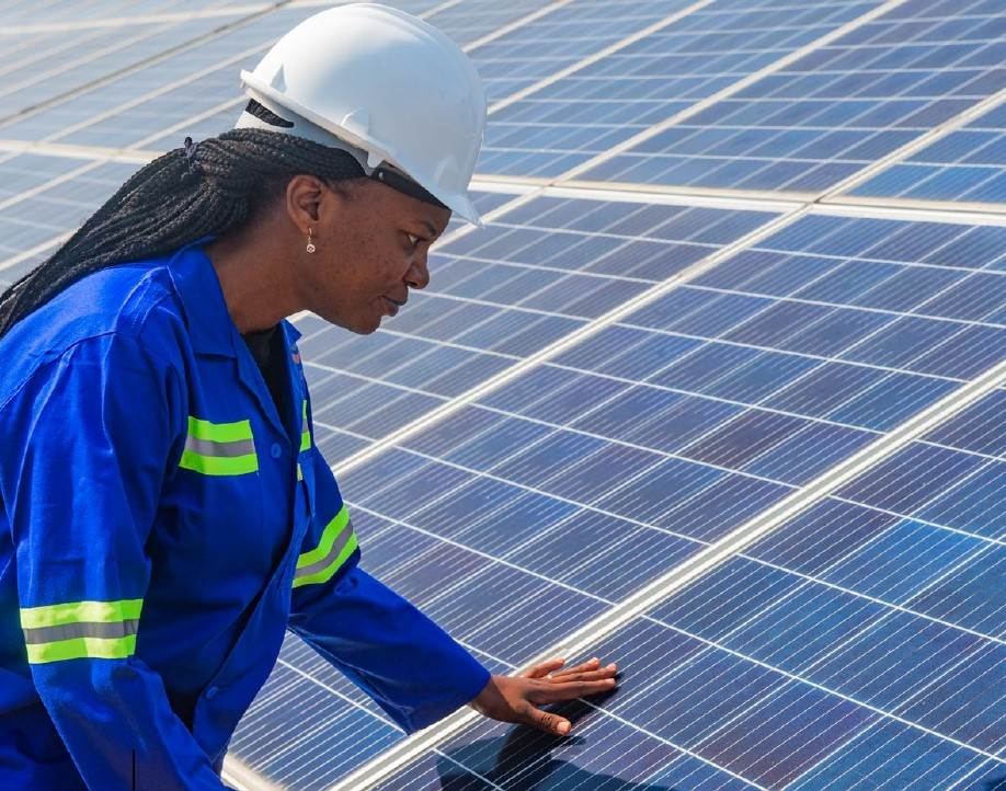 Woman with solar panels - Photo:Norfund