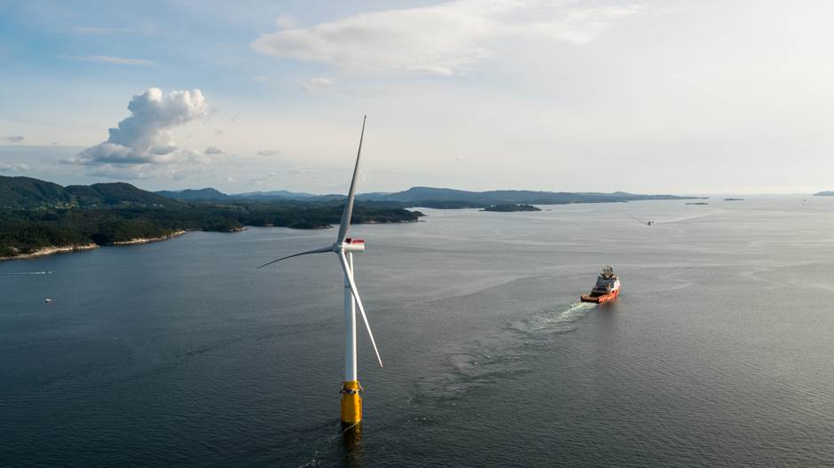 Floating offshore wind turbine in coastal setting with offshore vessel in the distance - Photo:Equinor - Øyvind Gravås