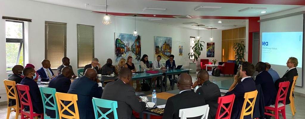 A large group of people sitting on colorful chairs watching a presentation. - Photo:Royal Norwegian Embassy in Kampala