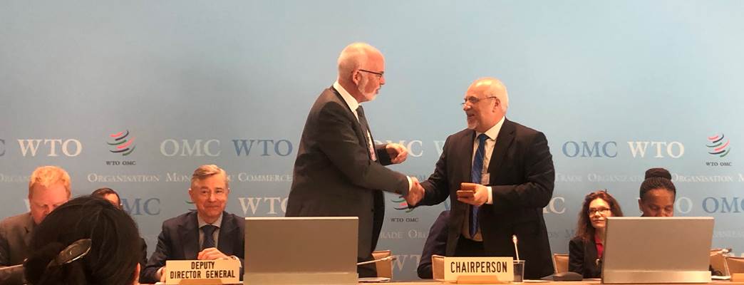 Incoming chair, Dagfinn Sørli, receives the ceremonial gavel from a former chair, Ambassador Peter Brňo