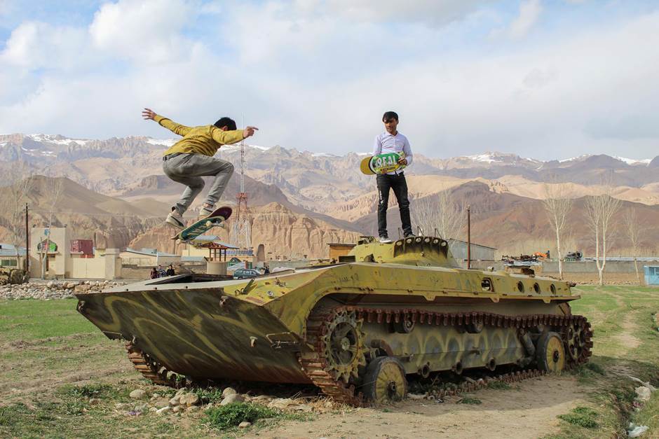Two Afghan skaters from Bamyan province skating on a tank.