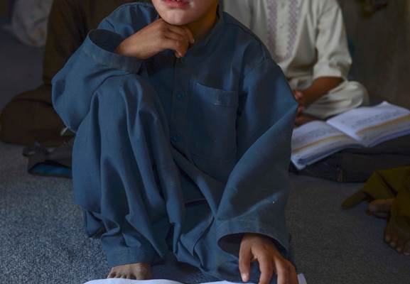 An Afghan child is seen while studying in a local school, September 2016, Qandahar, Afghanistan