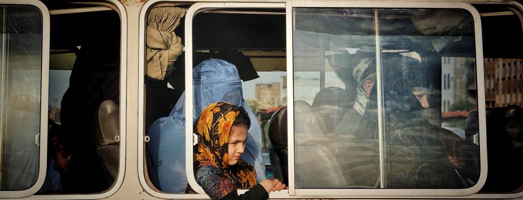 An Afghan girl with her mother while sitting on a mini-bus, June 2020, Karukh district of Herat prov