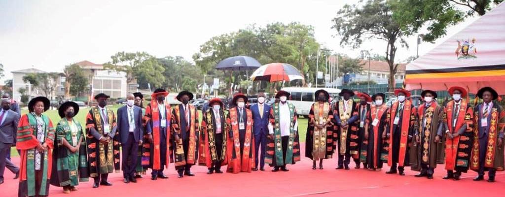 A number of professors standing in a line posing for the camera. - Photo:Nkoola Joseph