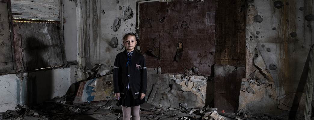 School girl in class room destroyed by armed conflict - Photo:GCPEA