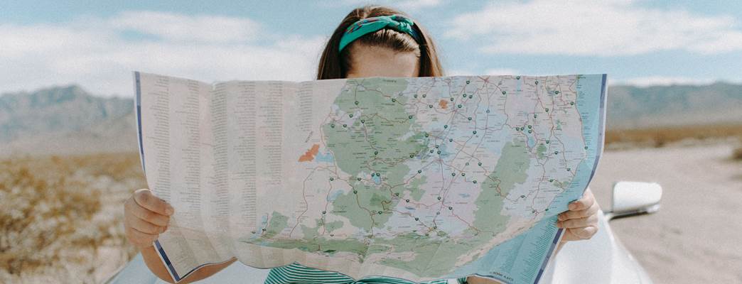 Girl looking at a map  - Photo:Leah Kelley