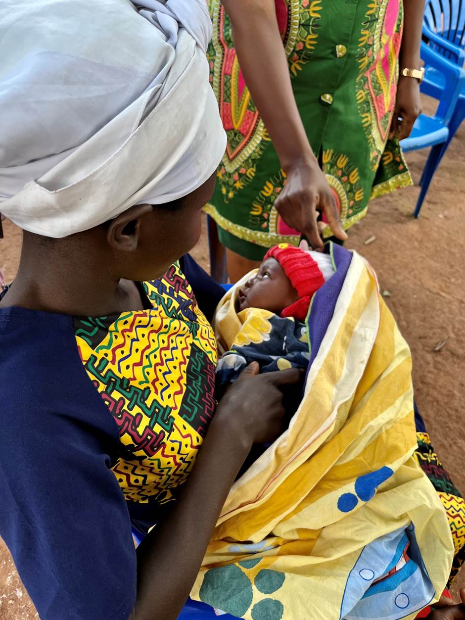 Teenage mother holding her baby in Kamuli District in Eastern Uganda