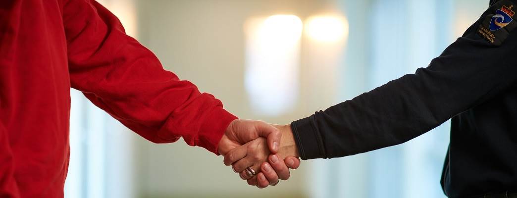 Handshake between correctional officer and inmate